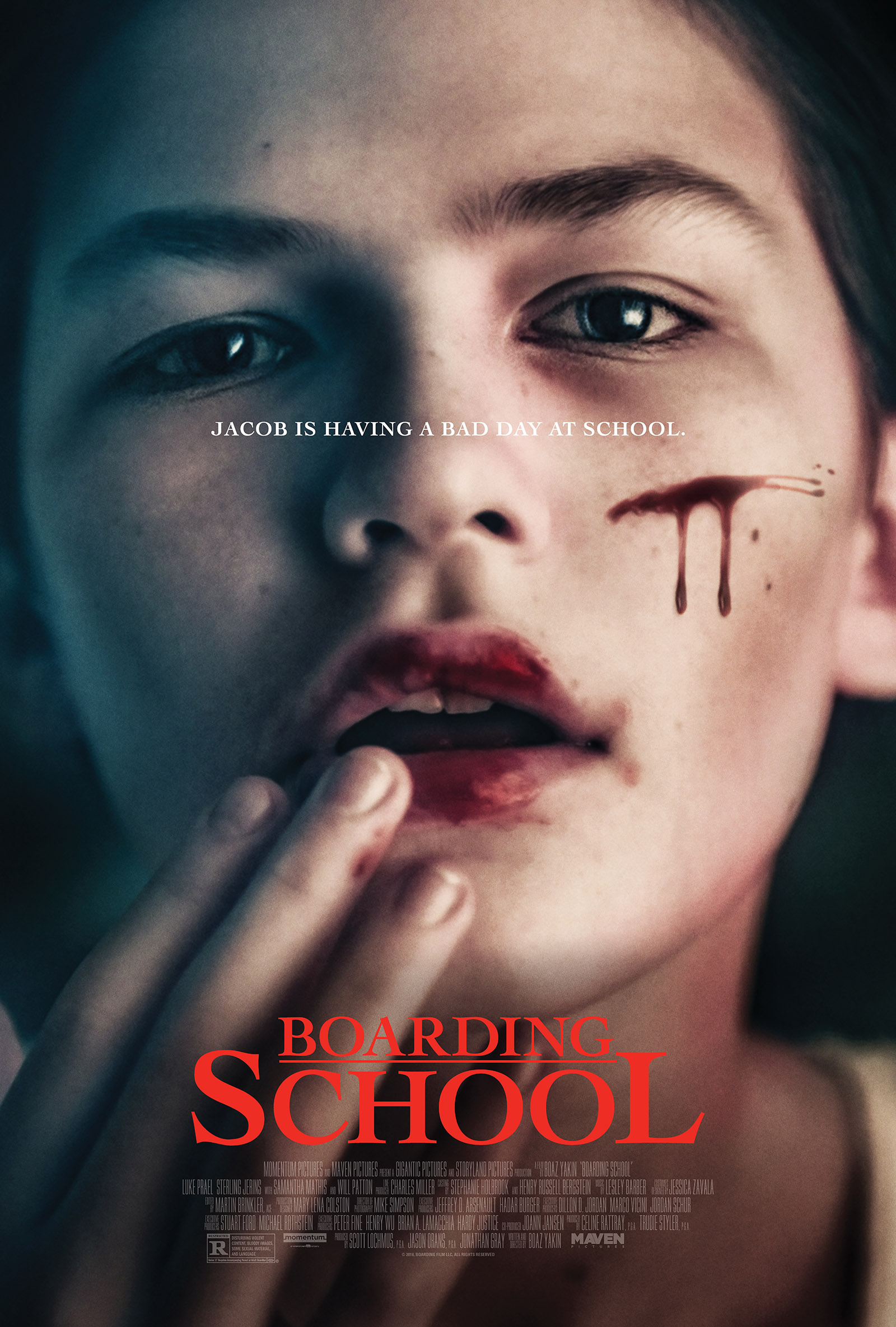 Movie poster with a pale young boy with blood on his lips and cheek, holding his fingers to his lips with his mouth open. The poster text reads'Jacob is having a bad day at school.', with the movie title appearing in red below his face.